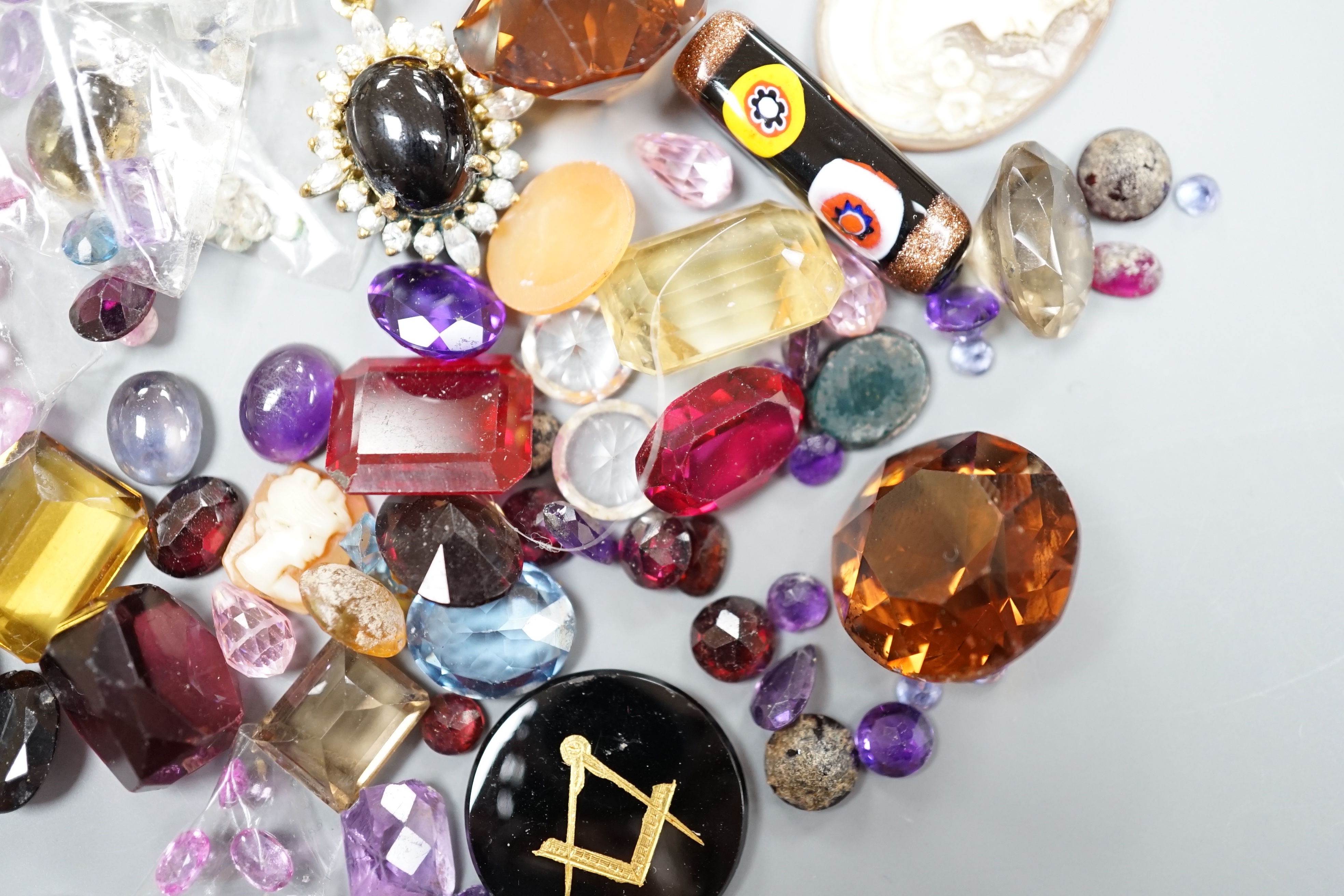 A quantity of assorted unmounted cut gemstones including small diamonds and other minor jewellery.